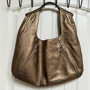 Christopher Kon Gold Leather Sak Shoulder Purse. 18.5” by 21” by 0.5”